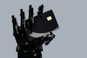 Real robotic hand with black payment card. Concept of Artificial intelligence in banking industry