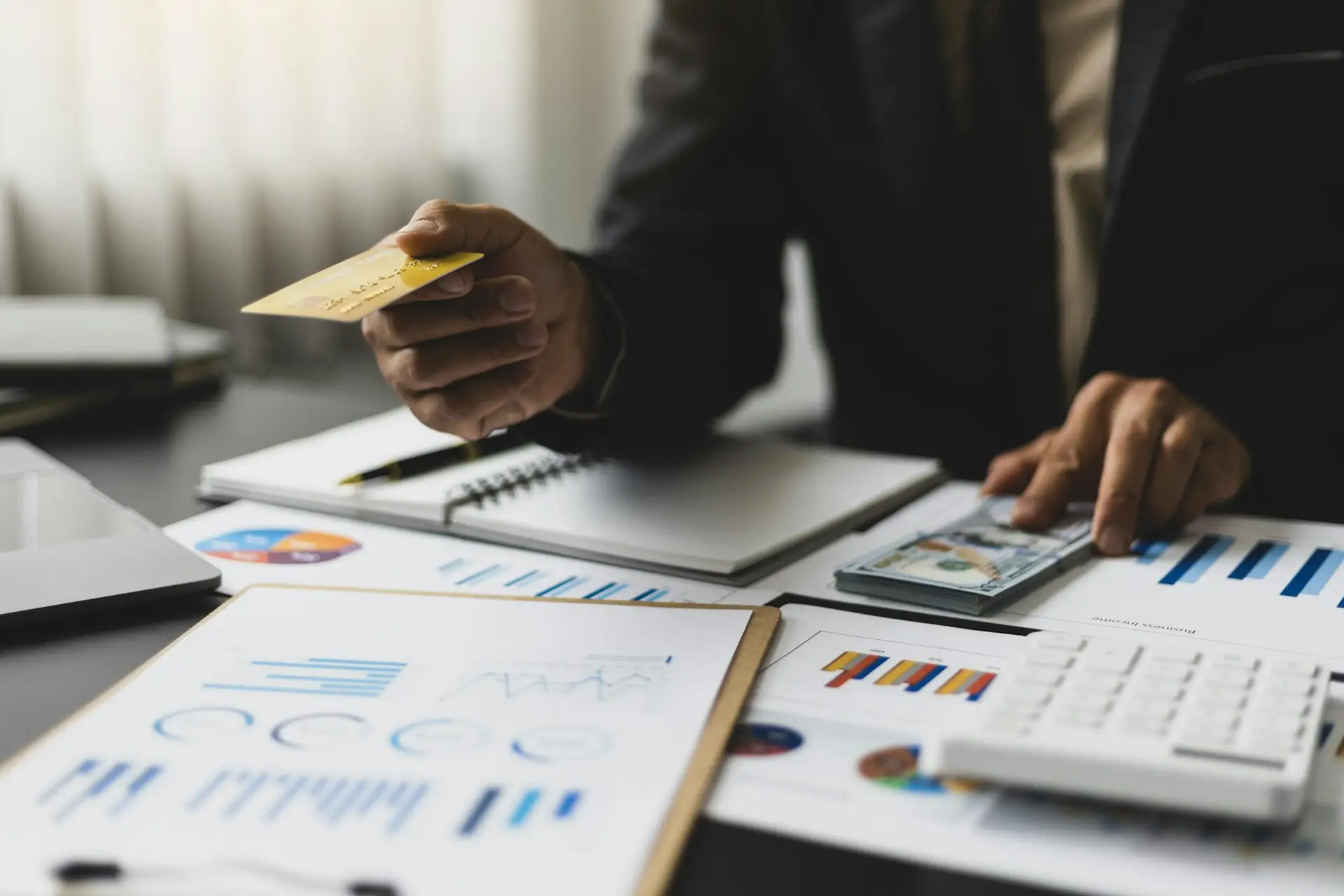 Businessman holding credit card and checking credit card limit for financial planning and budgeting.